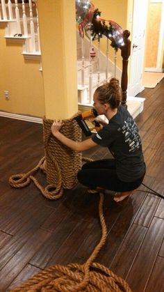 a young boy sitting on top of a wicker chair next to a wooden floor