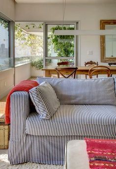 a living room filled with furniture and windows