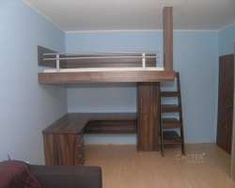 a loft bed with stairs and desk underneath