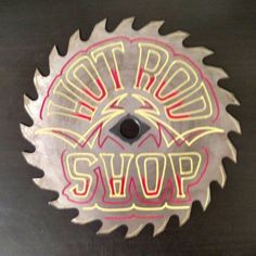 a circular saw blade with the words hot rod shop painted on it's side