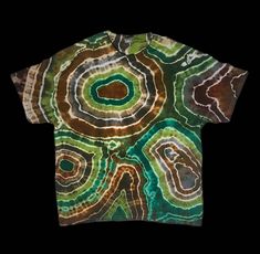 Earthy geode tie dye T-shirt filled with different shades of brown and green  This item is MADE TO ORDER ! This means that it will likely look slightly different than the one pictured, because no two tie dyes are exactly the same! The same colors and design will be used of course:) SIZES OFFERED  *All T-shirt designs are available in sizes small, medium, XL , 2XL , and 3XL .  *If you need a size that is not offered , or want a design in a child's size, feel free to message me!  *If want the desi Bohemian Green Relaxed Fit T-shirt, Earth Tone Clothing, Geode Tie Dye, Hippie T Shirts, Nature Shirts, Shirt Tie, Brown And Green, Tie And Dye, Cool Fits