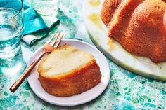 a bundt cake sitting on top of a white plate next to a knife and fork