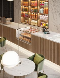 the interior of a store with lots of counter space and chairs, including two round tables