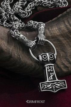 Vikings used necklaces with animals or beasts biting onto a ring where pendants were hung. This variant consists of a King Chain ending in Járngreipr, the iron gauntlets of Thor, that hold onto the hammer. The gauntlets have "THOR VIKI" written on them with runes, which translates to "Thor protect/bless". They hold onto the Grimfrost Stainless Steel Thor's Hammer. #viking #vikings #jewelry #grimfrost Vikings Jewelry, Norse Jewelry, Mens Silver Jewelry, Viking Pendant, Thor's Hammer, Pendant Ring, Viking Necklace, Mens Trendy Outfits, Chain Maille