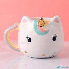 a ceramic cup with a unicorn's head on it