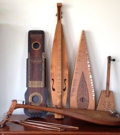 some musical instruments are sitting on top of a table next to a wall mounted instrument