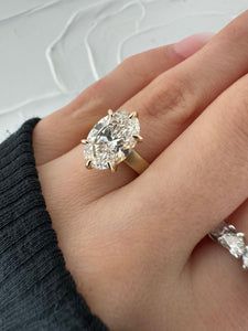 a woman's hand with two engagement rings on it