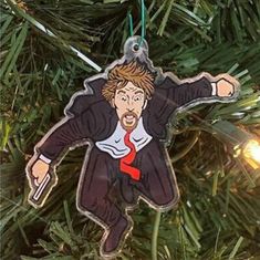 a christmas ornament hanging from a tree with a man in suit and tie