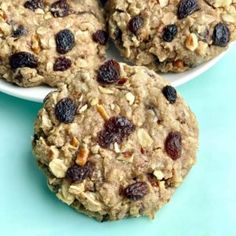 three cookies with raisins and nuts on a plate