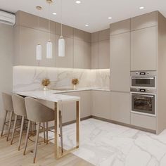 a modern kitchen with marble counter tops and beige cabinets, along with bar stools