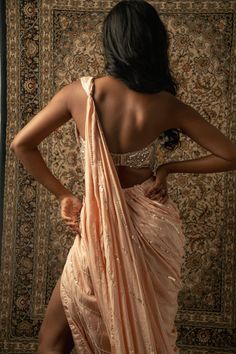 This baby peach pre-draped saree is a vision of elegance, crafted from Linen Satin fabric that glimmers with every movement. Paired with a Net blouse, the ensemble radiates sophistication and charm. The intricately hand-embroidered blouse adds a touch of glamour, making it perfect for a cocktail or reception, whether for the bride or her bridesmaids. With its timeless allure and delicate detailing, this saree is sure to captivate attention and leave a lasting impression on any special occasion.F Satin Silk Saree, Net Blouse, Draped Saree, Tuxedo Accessories, Net Blouses, Summer Bride, Drape Saree, Summer Wedding Guests, Beach Bride