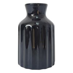 a black vase sitting on top of a white table