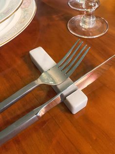 a fork and knife sitting on top of a wooden table