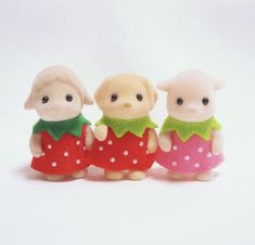 three little pigs are standing next to each other wearing red and green dresses with polka dots on them