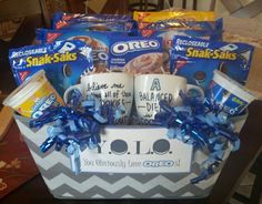 a gift basket with coffee mugs, candy and snacks for someone's birthday