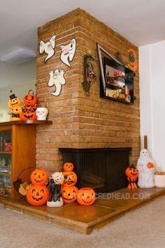 a living room decorated for halloween with pumpkins on the mantle and decorations around the fireplace