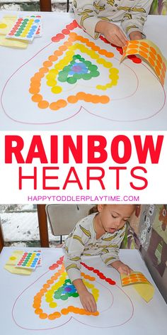 a young boy is making a rainbow heart craft with construction paper and glue on the table