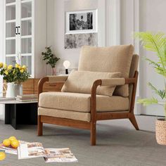 a living room scene with focus on the chair and flowers in the vase, which is sitting on the floor