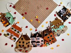 a group of small houses sitting on top of a white table next to each other