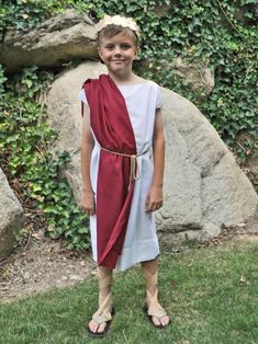 a young boy dressed in roman clothing