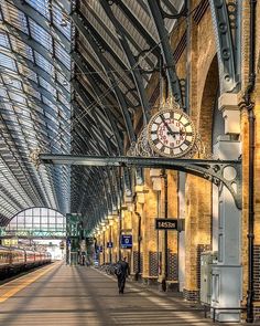 a train station with a large clock on the wall