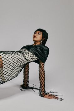 a woman in fishnet stockings is posing for the camera