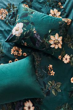 two green pillows with flowers on them