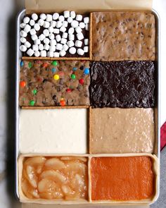 a tray filled with lots of different types of desserts and marshmallows