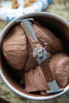 a cup filled with chocolate ice cream on top of a counter