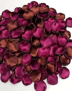 a pile of purple and brown satin flowers