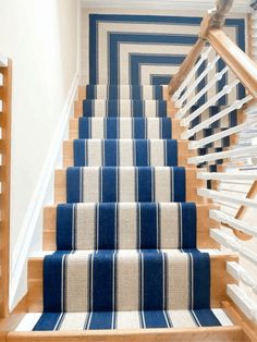 blue and white striped carpeted stairs leading up to the second floor in a home