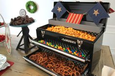 an assortment of cookies and pretzels are on display in a buffet style case