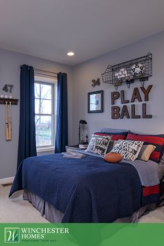 a bed room with a neatly made bed and pictures on the wall