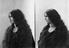 an old black and white photo of a woman with long hair