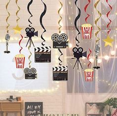 some decorations are hanging from the ceiling in a room with brick walls and lights on it