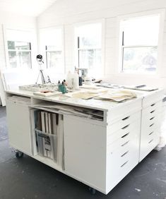 a white workbench with lots of papers on it