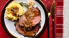 a plate with meat, mashed potatoes and gravy