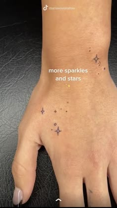 a person's hand with stars on it and the words more sparkles and stars