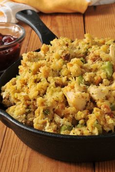 a pan filled with food sitting on top of a wooden table