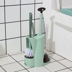 a mop and duster sitting on the floor in a bathroom