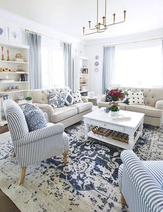 a living room with blue and white striped furniture