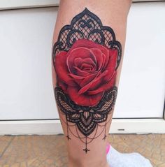 a woman's leg with a rose tattoo on it