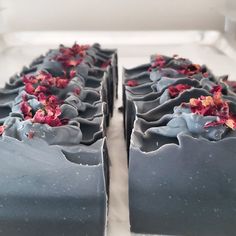 two bars of chocolate with flowers on them sitting on a counter next to each other