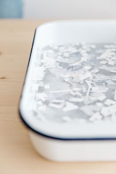 a close up of a plate on a table with confetti sprinkles