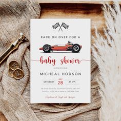 the race car baby shower is on display next to a pair of scissors and a key