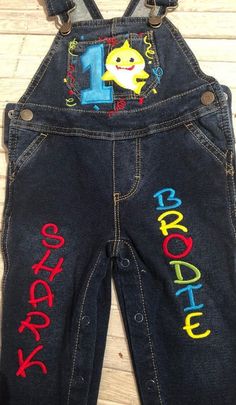 Baby Shark Birthday Overalls Custom machine embroidered with name and age of your choice. Other sharks availble upon request. Okie Dokie Brand Overalls 95% cotton/5% Spandex 12 month 20.5-24.5 18 month 24.5-27.5 24 month 27.5-30lbs Birthday Overalls, Baby Shark Birthday, Okie Dokie, Baby Boy Clothing Sets, Shark Party, Shark Birthday, Boy First Birthday, 1st Boy Birthday, Baby Shark