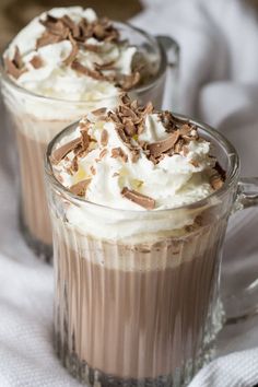 two cups filled with whipped cream and chocolate