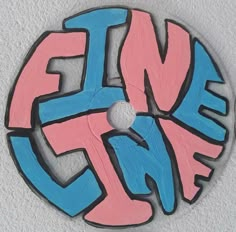 a circular sign with the word fun painted on it's side in blue, pink and black