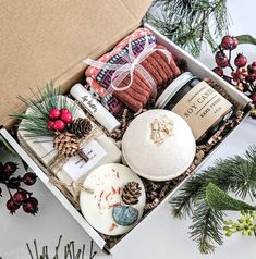 a box filled with lots of different items next to pine cones and other christmas decorations