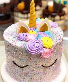 there is a unicorn cake with sprinkles on it